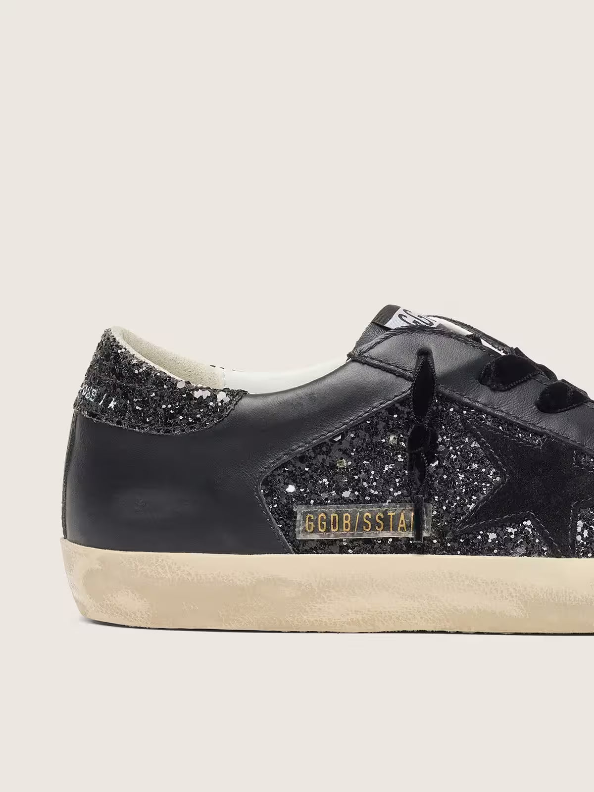 Super-Star pour femme à paillettes noires avec étoile en daim noir et empiècements en cuir